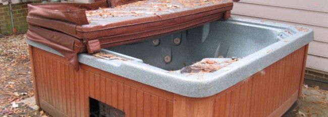 Old hot tub with leaves gathering. Hot Tub Removal Services in Salem OR by Mike & Dad's Hauling