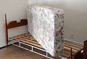 Old mattress on bed. Mattress Disposal Services and mattress recycling in Salem OR by Mike & Dad's Hauling