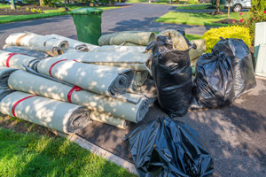 Pile of carpeting and carpet padding. Mike and Dad's Hauling provides quality carpet removal and carpet disposal services in Salem OR.