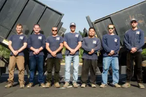 Mike & Dad's Salem team standing in front of trucks