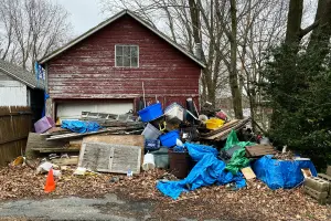 Large pile of junk outside a detached garage in Salem