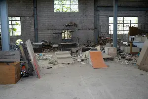 A messy commercial building before cleanup by Mike & Dad's in Salem