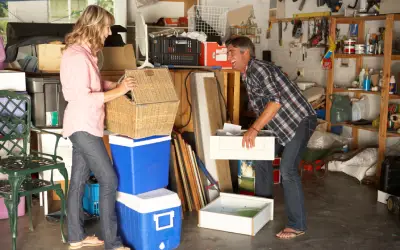 couple getting started with spring cleaning in the garage