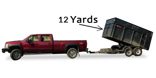 A red pickup truck with its large black dump bed raised for Mike & Dad's Hauling's 12 Yard Truck Loads.