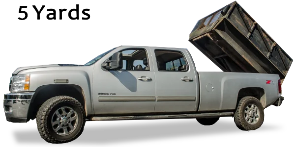 A grey pickup truck with its large black dump bed raised for Mike & Dad's Hauling's 5 Yard Truck Loads.